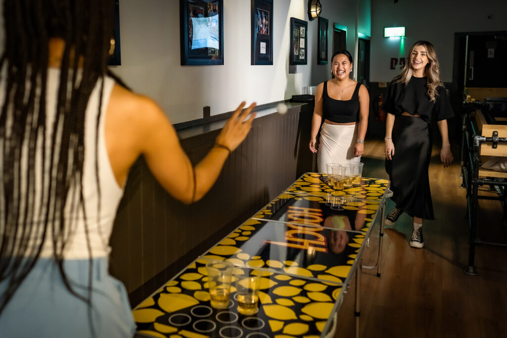 girls playing beer pong at Bierkeller